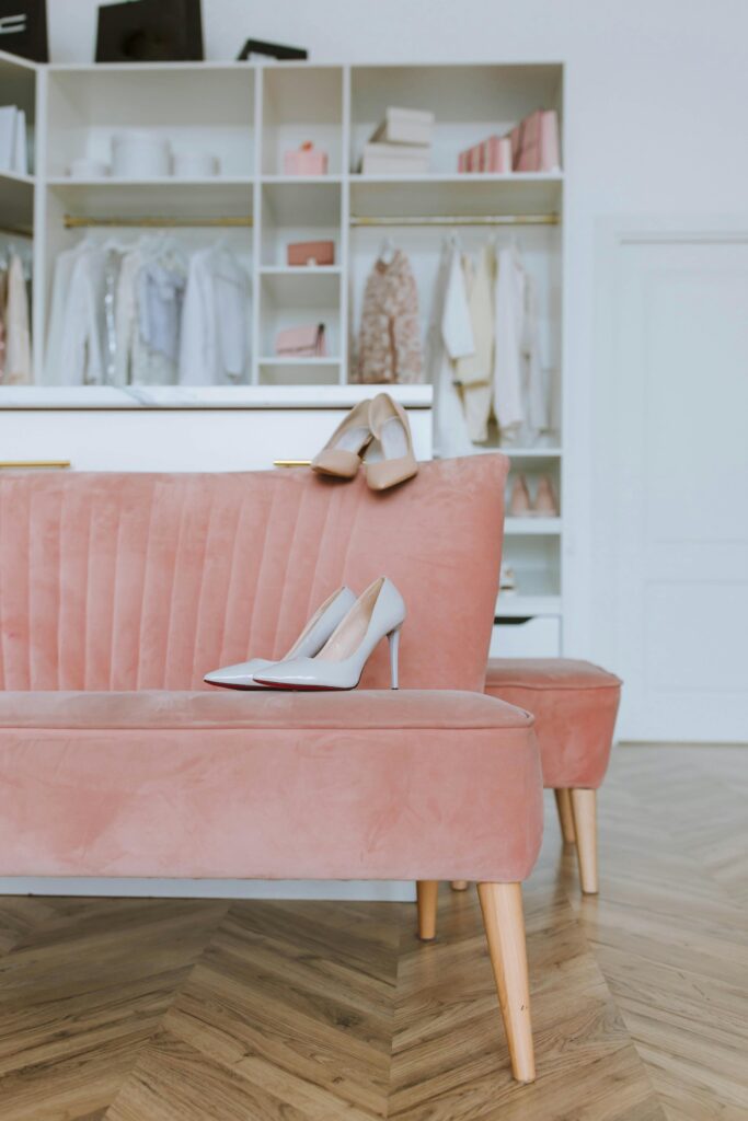 beautiful walk in closet with pink and gold details