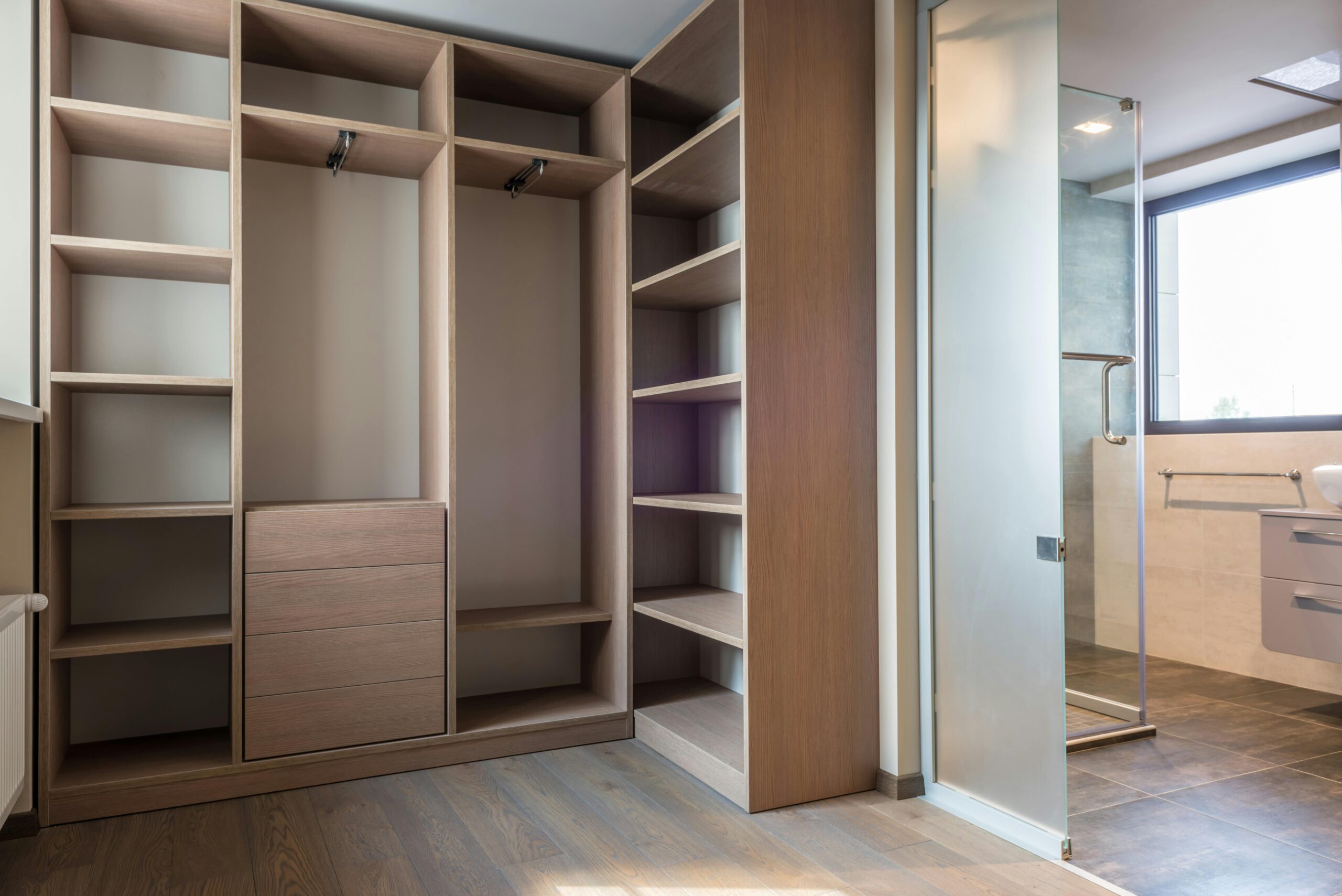 Custom walk-in closet with built-in shelving, hanging space, and drawers